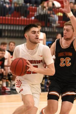 W&J junior John Rosario (J.R.) Mazza gaurds against Waynesburg opponent on basketball court.